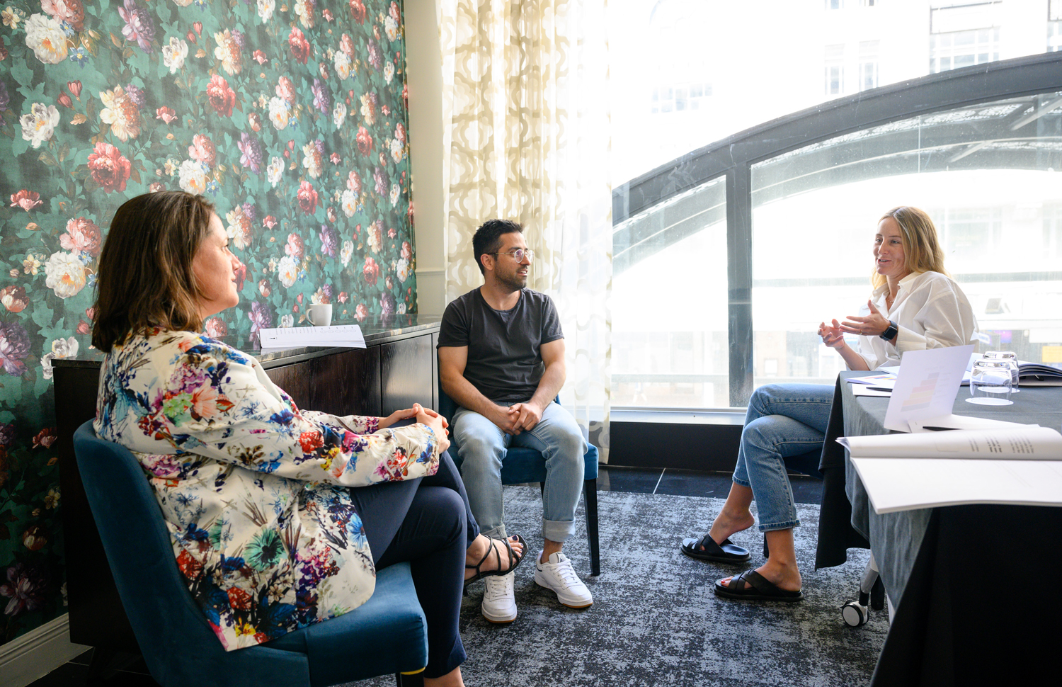 A photo of a group of people attending a leadership and management course, sitting together to discuss the course